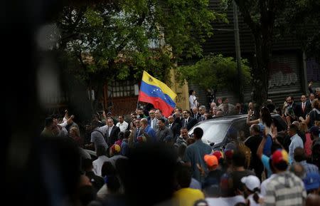 People arrive at a session of Venezuela's opposition-controlled National Assembly that appoints alternative judges to the Supreme Court in Caracas, Venezuela, July 21, 2017. REUTERS/Ueslei Marcelino