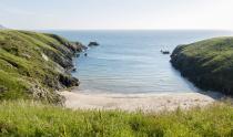 <p>One of the best beaches in North Wales, Porth Iago boasts clear, turquoise waters, making it a delightful spot for swimming. One of Wales' more 'secret' sands, it's a must-visit on the Llyn Peninsula. There's an ancient hill fort lookout that overlooks the beach and the rocks on its north side are great for fishing, with bass known to be caught here.</p><p><strong>Where to stay: </strong>A peaceful cottage around a 13-minute drive away in Anelog, this cute rural rental is great for couples, families or a group of friends. It sleeps five and there's plenty of character and countryside views. <a class="link " href="https://go.redirectingat.com?id=127X1599956&url=https%3A%2F%2Fwww.sykescottages.co.uk%2Fcottage%2FNorth-Wales-Snowdonia-Anelog%2FTy-Hen-954304.html&sref=https%3A%2F%2Fwww.redonline.co.uk%2Ftravel%2Ftravel-guides%2Fg33008606%2Fbest-beaches-wales%2F" rel="nofollow noopener" target="_blank" data-ylk="slk:SEE INSIDE;elm:context_link;itc:0;sec:content-canvas">SEE INSIDE</a></p>