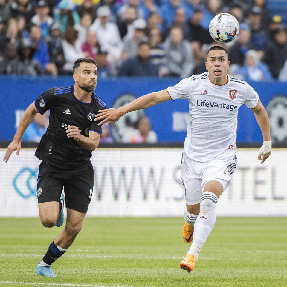 CF Montreal's Rudy Camacho, left, and Real Salt Lake's Bobby Wood chase down the ball during the second half of an MLS soccer game in Montreal, Sunday, May 22, 2022. (Graham Hughes/The Canadian Press via AP)