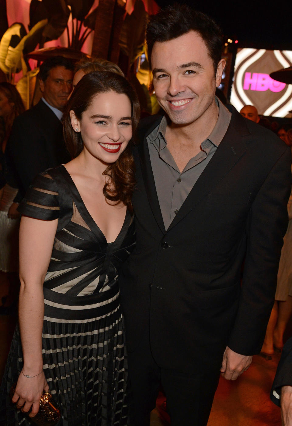 Seth MacFarlane and Emilia Clarke posing together at an event, they're both wearing formalwear and smiling