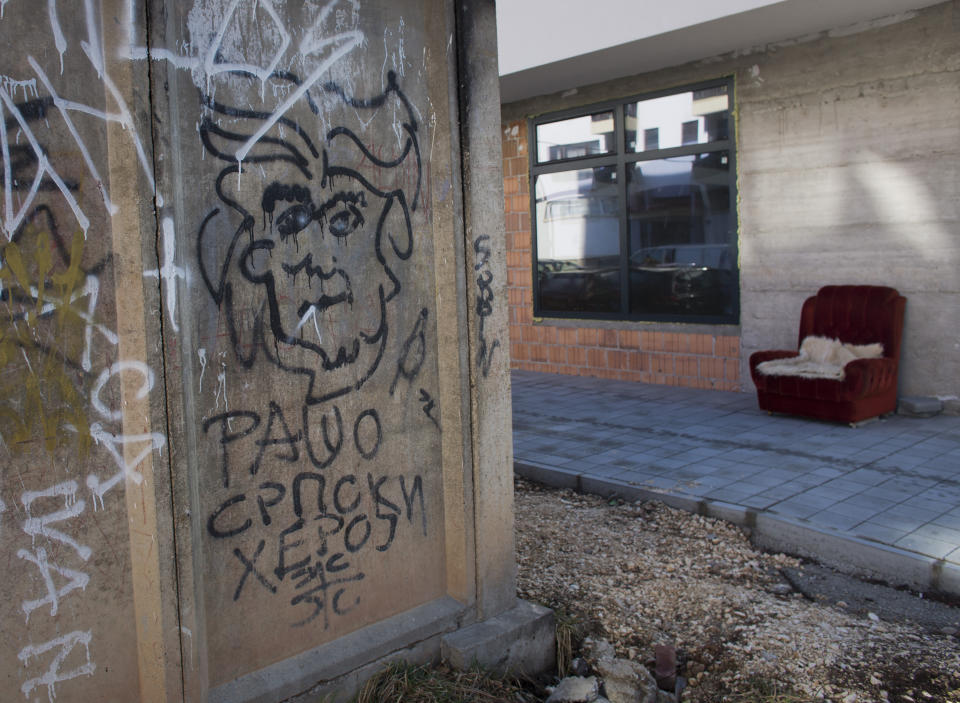 In this Sunday, March 17, 2019 photo, graffiti depicting Bosnian Serb wartime leader Radovan Karadzic on a wall in the Bosnian Serb wartime stronghold of Pale, Bosnia-Herzegovina. Nearly a quarter of a century since Bosnia's devastating war ended, former Bosnian Serb leader Radovan Karadzic is set to hear the final judgment on whether he can be held criminally responsible for unleashing a wave of murder and mistreatment by his administration's forces. United Nations appeals judges on Wednesday March 20, 2019 will decide whether to uphold or overturn Karadzic's 2016 convictions for genocide, crimes against humanity and war crimes and his 40-year sentence. The text in Cyrillic reads: "Radovan, Serbian hero". (AP Photo/Darko Bandic)