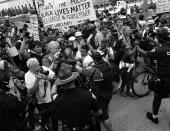 <p>An Akron police officer uses his bicycle to push journalists and anti-Trump demonstrators away from members of the Bible Believers group. (Photo: Khue Bui for Yahoo News)</p>