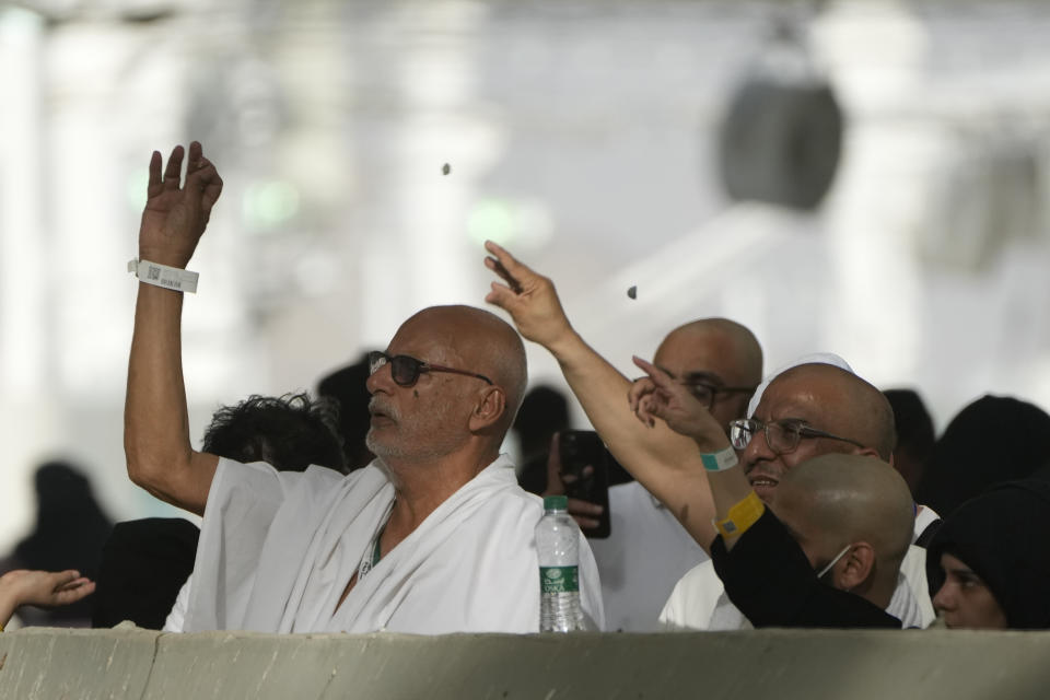 Pilgrims cast stones at a pillar in the symbolic stoning of the devil, the last rite of the annual Hajj pilgrimage, in Mina near the holly city of Mecca, Saudi Arabia, Wednesday, June 28, 2023. (AP Photo/Amr Nabil)