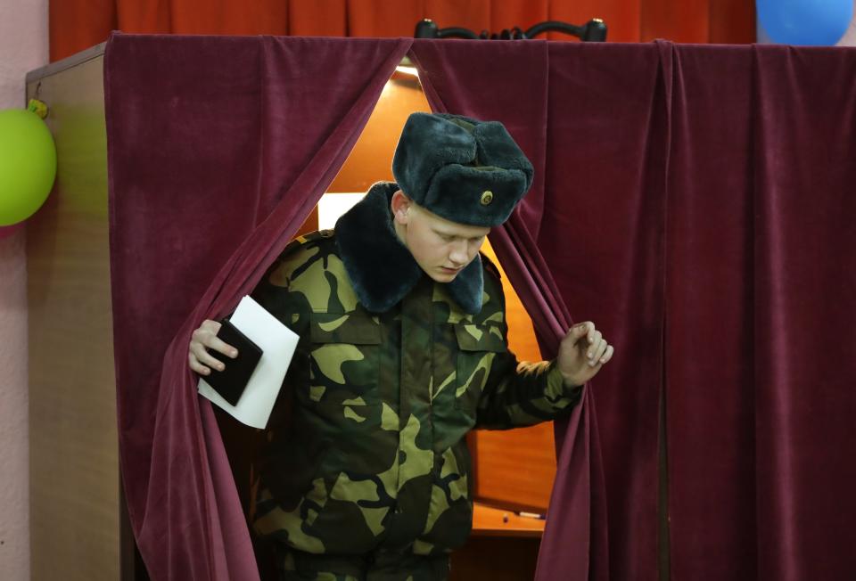 A Belarus' Army serviceman casts his ballot at a polling station during parliamentary elections, in Minsk, Belarus, Sunday, Nov. 17, 2019. (AP Photo/Sergei Grits)