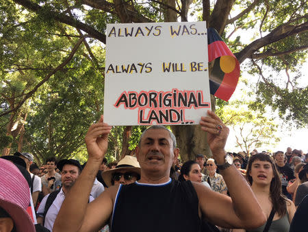 A man holds up a placard during a demonstration on Australia Day in Sydney, January 26, 2019. REUTERS/Stefica Nicol Bikes