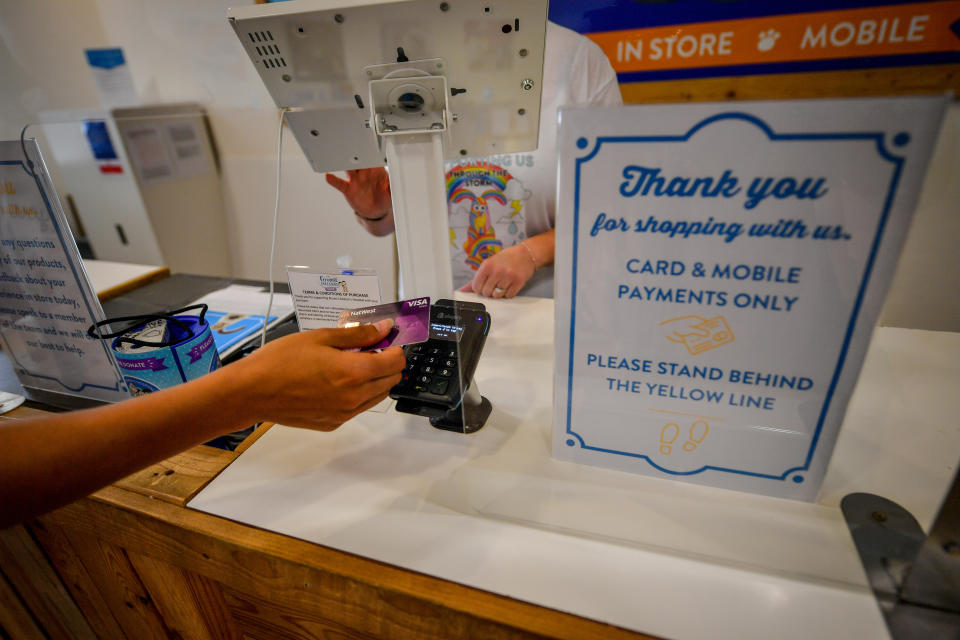 Contactless payment behind a plastic screen in a shop in Bristol as non-essential shops in England open their doors to customers for the first time since coronavirus lockdown restrictions were imposed in March. (Photo by Ben Birchall/PA Images via Getty Images)