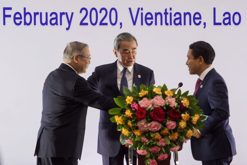 China's Foreign Minister Wang Yi speaks to Secretary of Foreign Affairs of the Philippines Lopez and Laos Foreign Minister Kommasith during a press conference in Vientiane