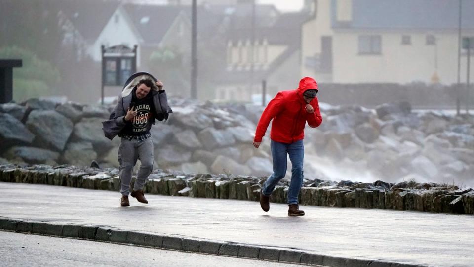 People walking in high winds at Salthill, Galway, during Storm Isha (Niall Carson/PA Wire)
