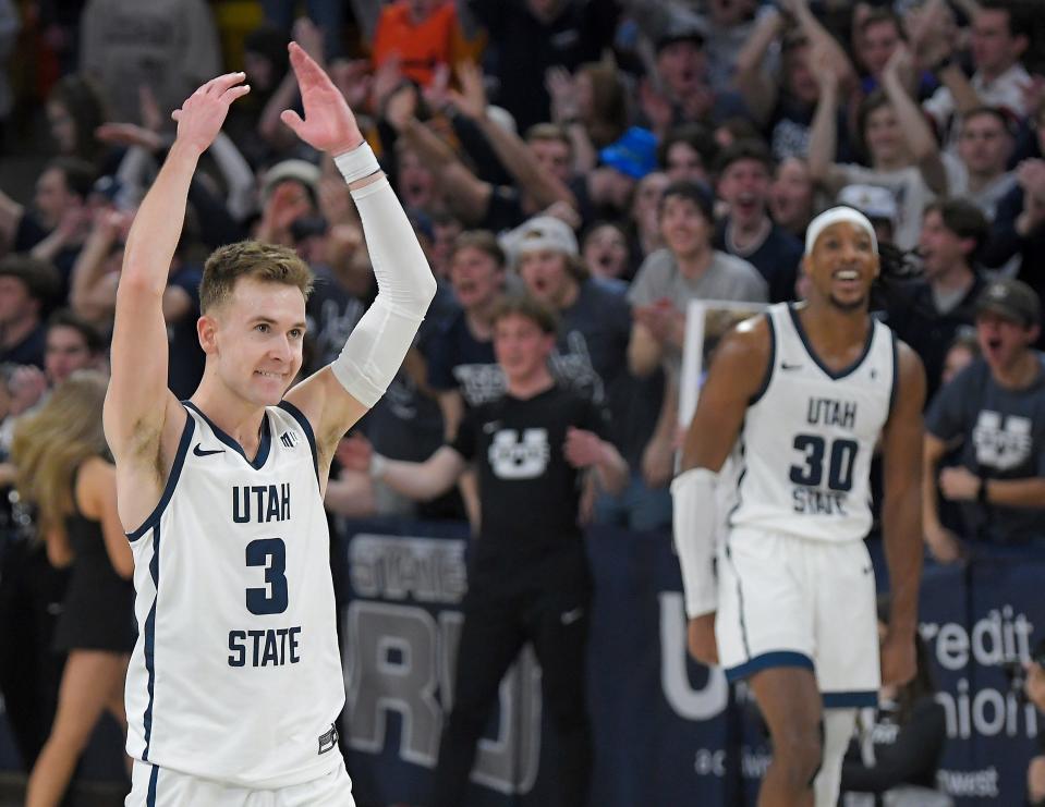 Utah State guard Steven Ashworth (3) and forward Dan Akin celebrate after defeating Boise State in an NCAA college basketball game Saturday, March 4, 2023, in Logan, Utah. (Eli Lucero/The Herald Journal via AP)