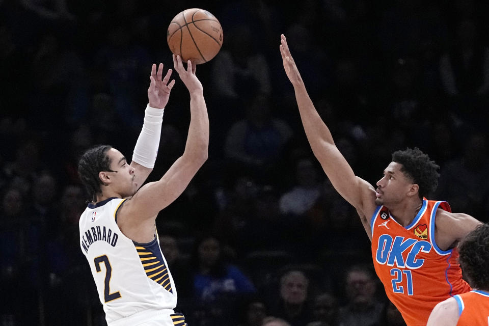 Indiana Pacers guard Andrew Nembhard (2) shoots over Oklahoma City Thunder guard Aaron Wiggins (21) in the first half of an NBA basketball game Wednesday, Jan. 18, 2023, in Oklahoma City. (AP Photo/Sue Ogrocki)