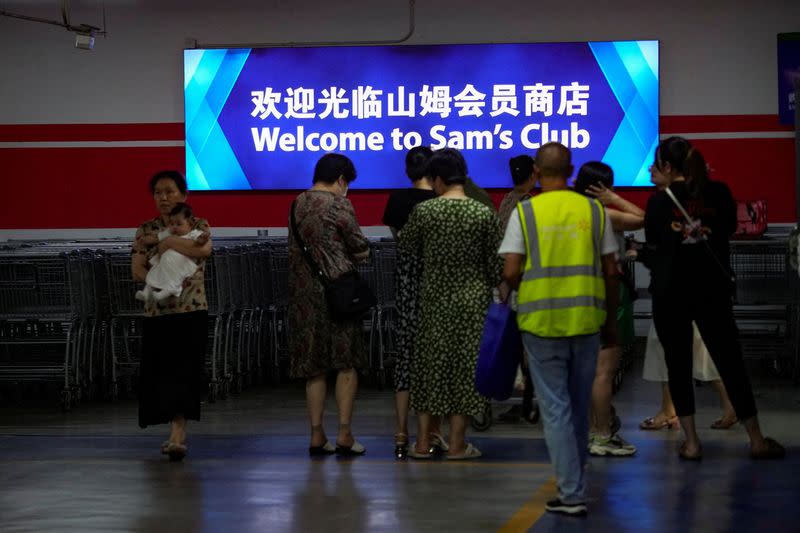 People arrive at Sam's Club store in Shanghai