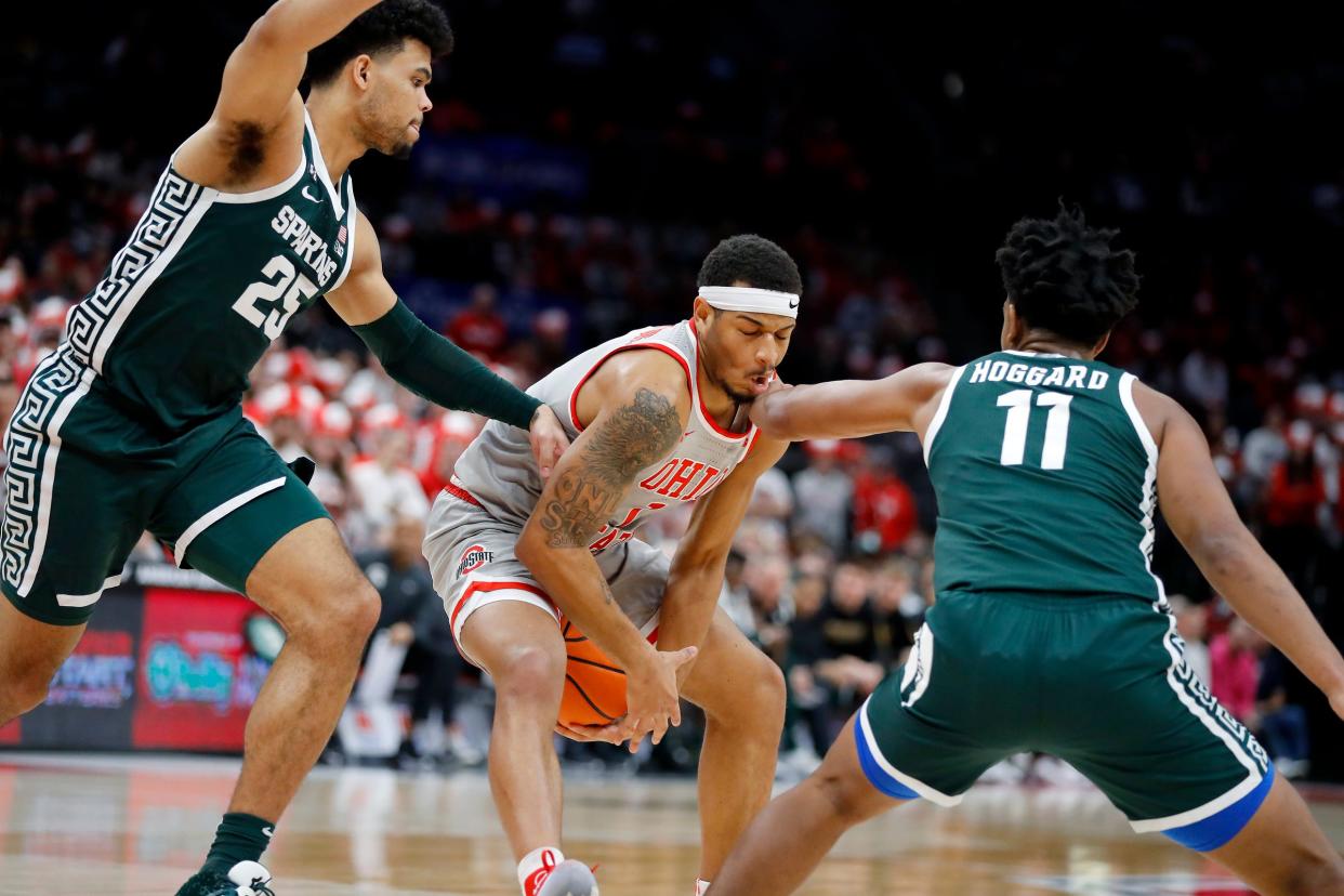 Ohio State Buckeyes guard Roddy Gayle Jr. (1) is hit in the face by Michigan State Spartans guard A.J. Hoggard (11) and Spartans forward Malik Hall (25) during the second half at Value City Arena.