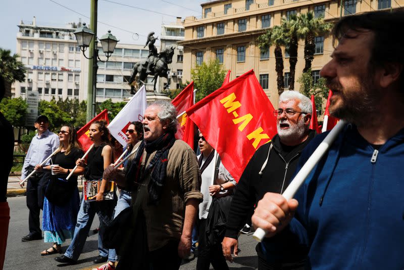 Protesters take part in a rally commemorating May Day in Athens