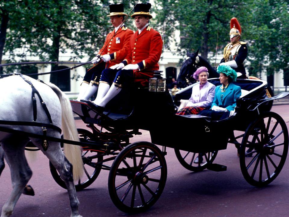 queen elizabeth and princess margaret in a horse drawn carriage
