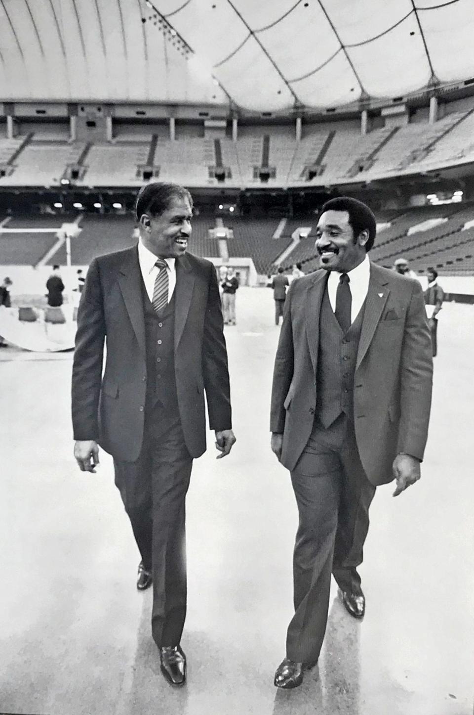 Coach Eddie Robinson of Grambling State University, left, and Mississippi Coach Archie Cooley walk in the Hoosier Dome ahead of the first Circle City Classic football game in 1984.