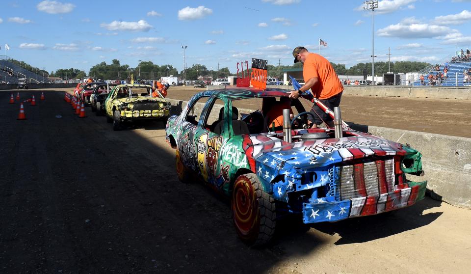 Craig Beaubien and his son Beau, 6, get ready to show their demolition derby car in the Best of Show contest.