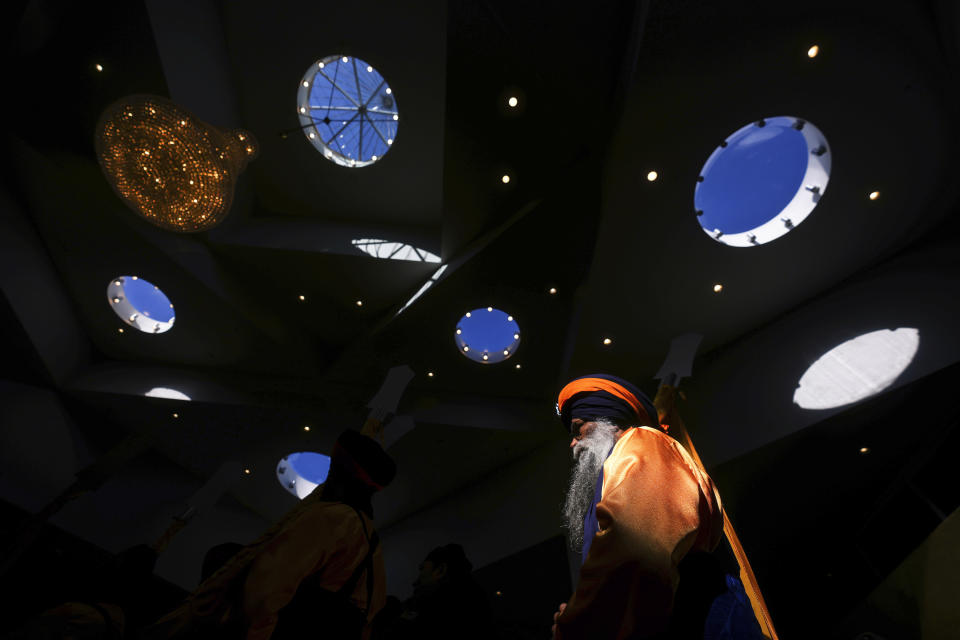 A parade leader walks into the Khalsa Diwan Society Sikh temple during a ceremony before the Vaisakhi parade in Vancouver, on Saturday, April 13, 2024. Vaisakhi is a significant holiday on the Sikh calendar, commemorating the establishment of the Khalsa in 1699 and marking the beginning of the Punjabi harvest year. (Darryl Dyck/The Canadian Press via AP)