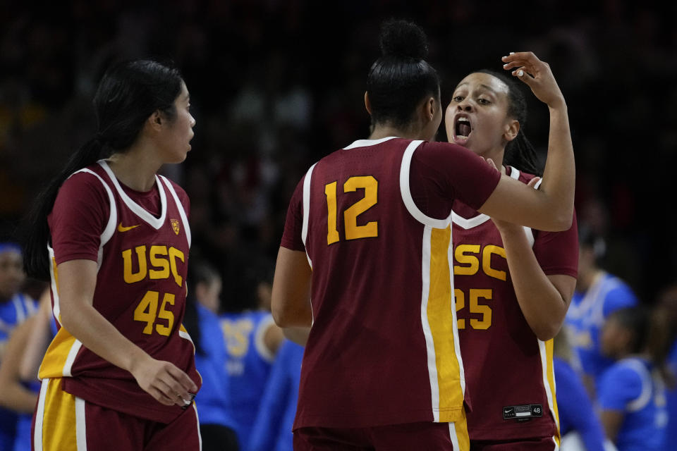 Southern California guard JuJu Watkins (12) talks with guard McKenzie Forbes (25) during the second half of an NCAA college basketball game against UCLA in Los Angeles, Sunday, Jan. 14, 2024. (AP Photo/Ashley Landis)