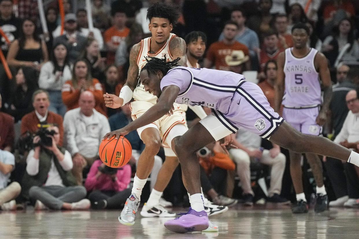 Kansas State forward Arthur Kaluma stumbles as he's guarded by Texas forward Dillon Mitchell during their Feb. 19 matchup at Moody Center in Austin, a Longhorns win. The teams meet again in Wednesday's second round of the Big 12 Tournament.