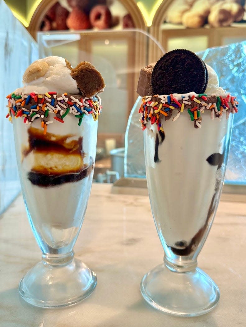 Two ice cream sundaes on a marble counter on a cruise ship