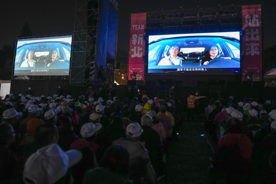 Supporters watch an ad showing then Taiwan Democratic Progressive Party (DPP) presidential candidate Lai Ching-te in a car driven by incumbent president Tsai Ing-wen during a rally held in New Taipei, Taiwan, on Saturday, Jan. 6, 2024. In the campaign ad, Taiwan's president-elect Lai Ching-te and incumbent president Tsai Ing-wen was shown driving steadily on the island's roads with Lai in the passenger seat, exchanging barbs and reflections on their years governing together. (AP Photo/Ng Han Guan)
