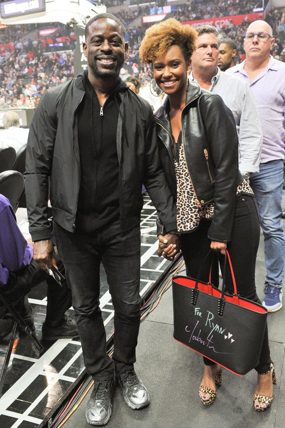 Sterling K. Brown and his wife, Ryan Michelle Bathe, watch the L.A. Clippers vs. Milwaukee Bucks basketball game in L.A. on Wednesday. 