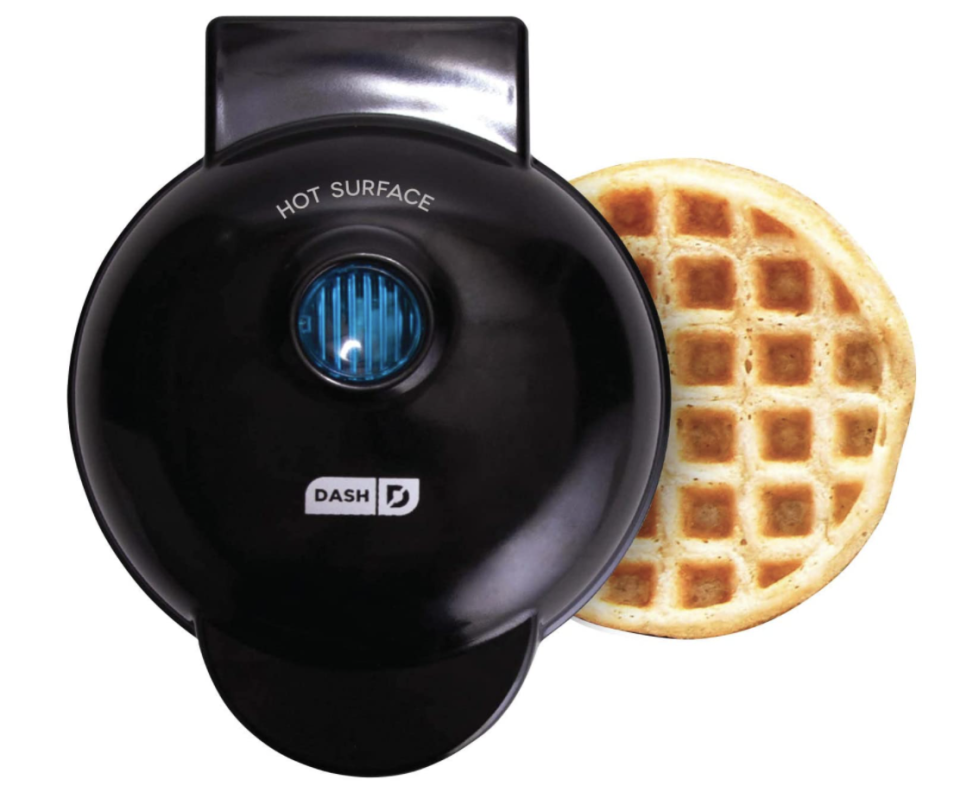 Dash Mini Maker: The Mini Waffle Maker in black with waffle (Photo via Amazon)