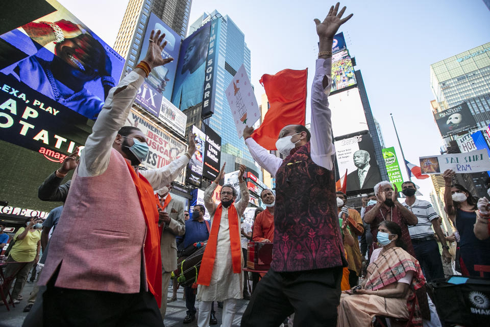 People gather in Times Square after the groundbreaking ceremony of a temple dedicated to the Hindu god Ram by Indian Prime Minister Narendra Modi, Wednesday, Aug. 5, 2020, in New York. Hindus rejoiced as Modi broke ground on a long-awaited temple of their most revered god, Ram, at the site of a demolished 16th century mosque. (AP Photo/Frank Franklin II)