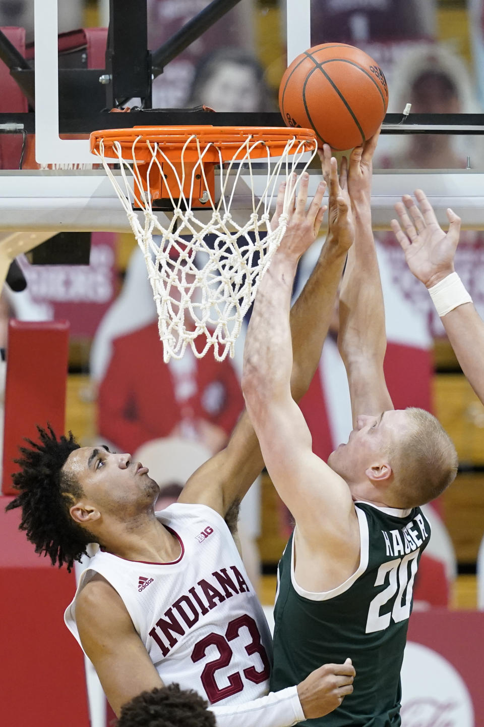 Michigan State's Joey Hauser (20) puts up a shot against Indiana's Trayce Jackson-Davis (23) during the second half of an NCAA college basketball game, Saturday, Feb. 20, 2021, in Bloomington, Ind. Michigan State won 78-71. (AP Photo/Darron Cummings)