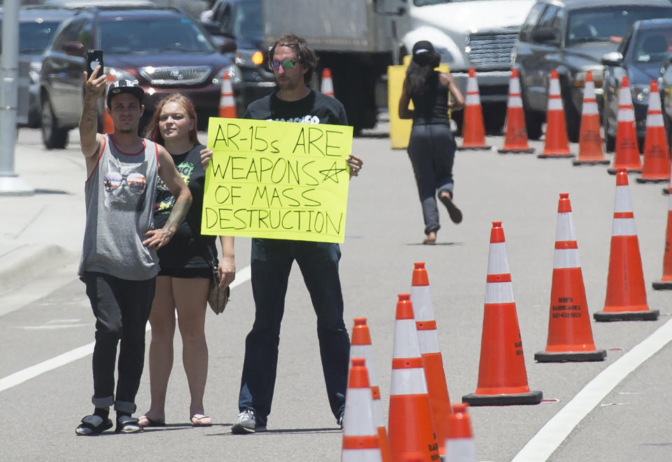 <p>A man holds a sign protesting assault weapons as President Obama arrives to meet with the families of those killed in Orlando, Fla. (Saul Loeb/AFP/Getty Images) </p>