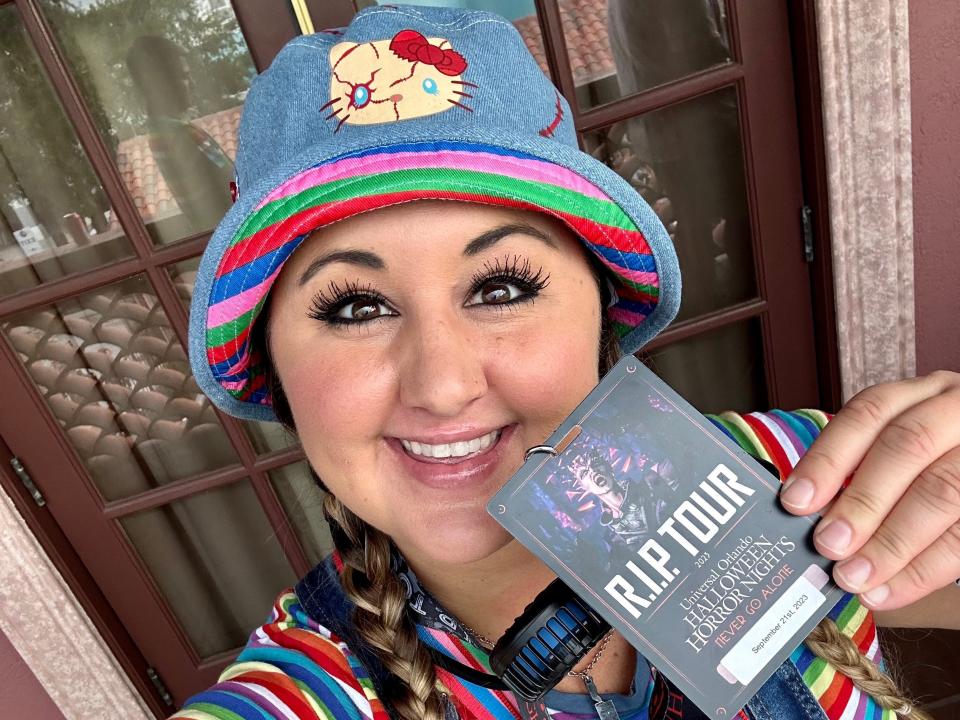 carly posing with a halloween horror nights rip tour lanyard at universal