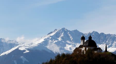 FILE PHOTO: A chapel is pictured in front of snow-covered mountains near the western Austrian village of Absam, October 31, 2012, before the Nov. 1 All Saints' Day holiday.REUTERS/Dominic Ebenbichler/File Photo