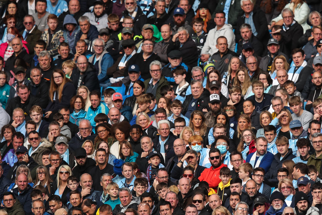 Two fans of Manchester City out of thousands still wear face coverings despite no social distance guidelines being in place anymore during the Coronavirus pandemic during the Premier League match between Manchester City and Burnley at Etihad Stadium on October 16, 2021 in Manchester, England. (Robbie Jay Barratt - AMA/Getty Images)