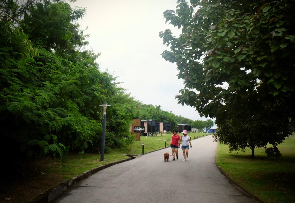 Two women walk their dog on Lazarus Island