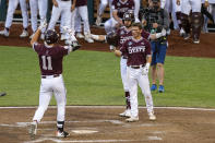 Mississippi State infielder Kellum Clark (11) celebrates his two run homer with Scott Dubrule in the eighth inning against Virginia during a baseball game in the College World Series Tuesday, June 22, 2021, at TD Ameritrade Park in Omaha, Neb. (AP Photo/John Peterson)