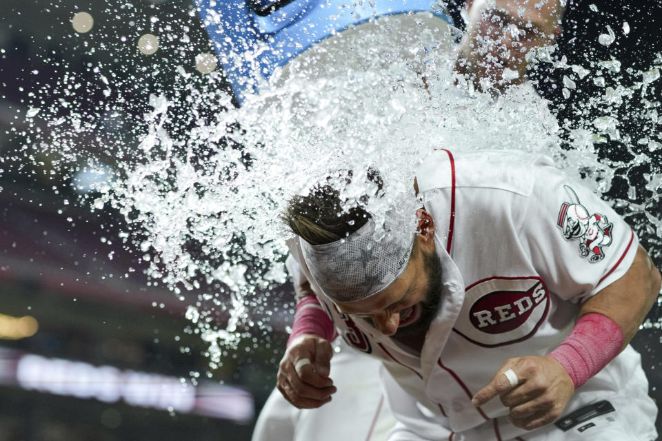 Cincinnati Reds' Nick Martini, front, is doused by teammate Nick Senzel after the final out of a baseball game against the Seattle Mariners in Cincinnati, Tuesday, Sept. 5, 2023. (AP Photo/Aaron Doster)