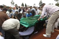 Relatives and Muslim faithful bury the slain body of Rehmad Mehbub, 18, who was killed in a crossfire between armed men and the police at the Westgate shopping mall, in Kenya's capital Nairobi September 22, 2013. Islamist militants were holed up with hostages on Sunday at a shopping mall in Nairobi, where at least 59 people have been killed in an attack by the al Shabaab group that opposes Kenya's participation in a peacekeeping mission in neighbouring Somalia. REUTERS/Thomas Mukoya (KENYA - Tags: CIVIL UNREST CRIME LAW OBITUARY) TEMPLATE OUT