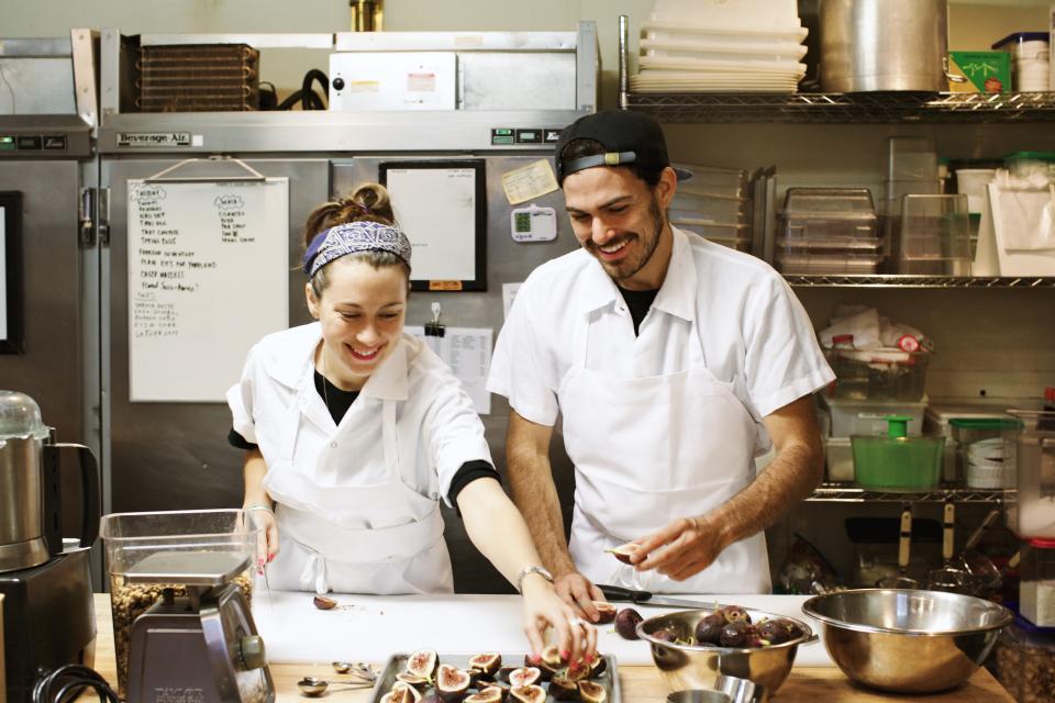 Van Leeuwen founders Laura O'Neill and Ben Van Leeuwen work with fresh figs in the kitchen of their production facility in Brooklyn, which supplies ice cream for all of the brand's New York City shops. (Photo: Sidney Bensimon)