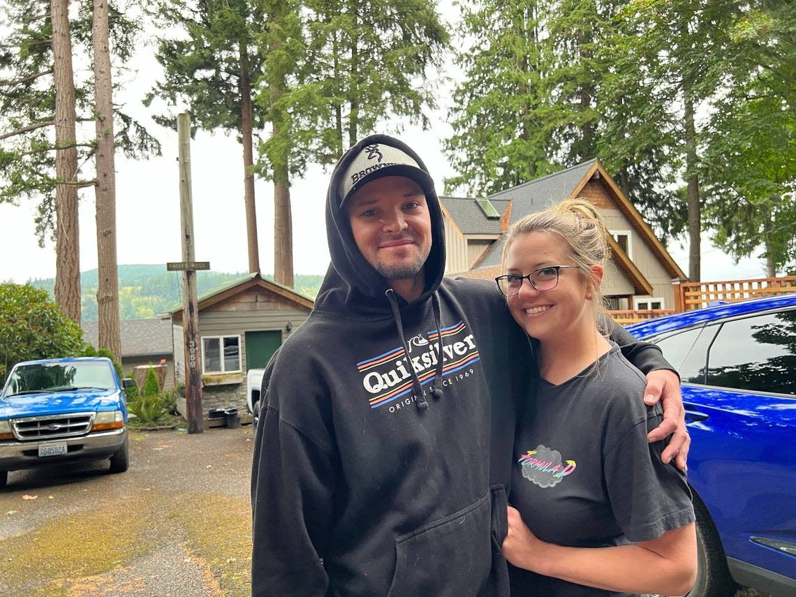 Derek and McKenna Hinton discuss their plans for evacuation outside their Blue Canyon Road home along the Lake Whatcom shore on Tuesday. Robert Mittendorf/The Bellingham Herald