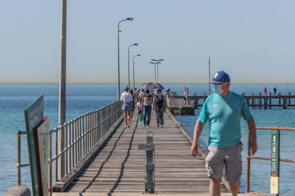 People walking along the pier in Rye in the Mornington Peninsula in Melbourne, Australia. 