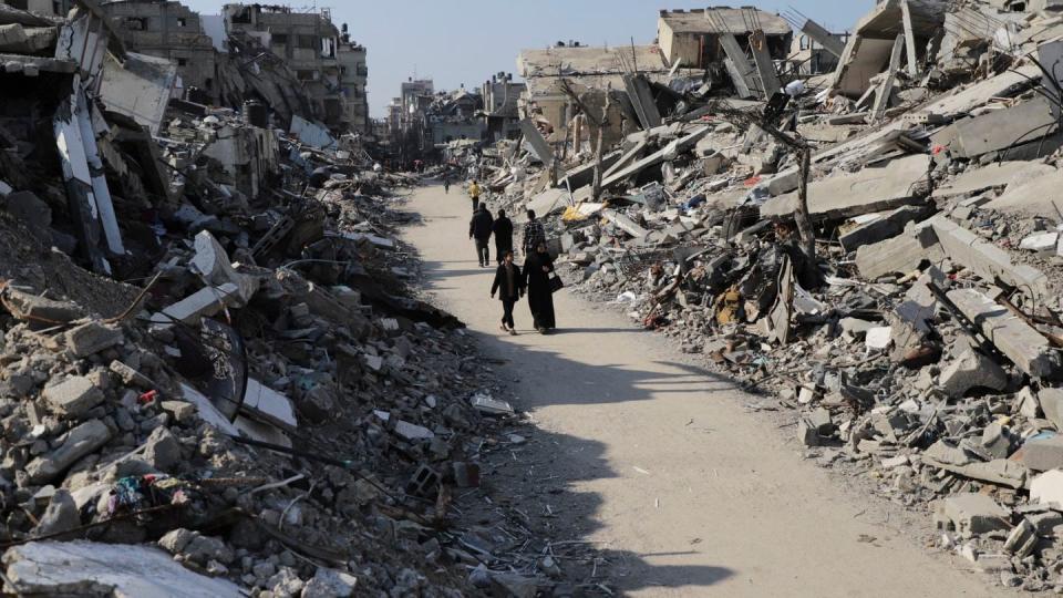 Palestinians walk through the destruction from the Israeli offensive in Jabaliya refugee camp in the Gaza Strip on Thursday, Feb. 29, 2024. (Mahmoud Essa/AP)