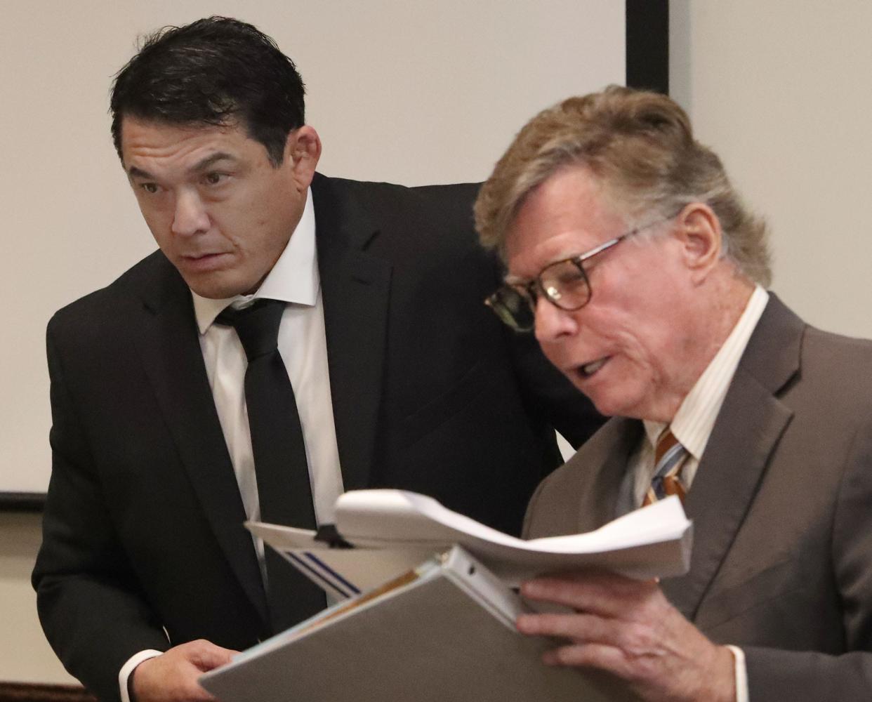 Joel Gingery, a jujitsu instructor accused of raping one of his then 18-year-old students, talks with his attorneys, including Michael Lambert, Tuesday, March 26, 2024, during his trial at the S. James Foxman Justice Center in Daytona Beach.