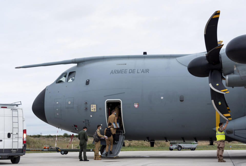 In this photo provided by the French Defense Ministry, French soldiers board a military Airbus A400M to evacuate French citizens from Afghanistan, Monday, Aug.16, 2021 in Orleans, central France. France is relocating its embassy in Kabul to the airport to evacuate all citizens still in Afghanistan, initially transferring them to Abu Dhabi. Evacuations have been in progress for weeks and a charter flight put in place by France in mid-July. (Etat-Major des Armees via AP)