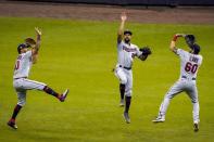 Minnesota Twins' Eddie Rosario, Byron Buxton and Jake Cave celebrate after a baseball game against the Milwaukee Brewers Wednesday, Aug. 12, 2020, in Milwaukee. The Twins won 12-2. (AP Photo/Morry Gash)