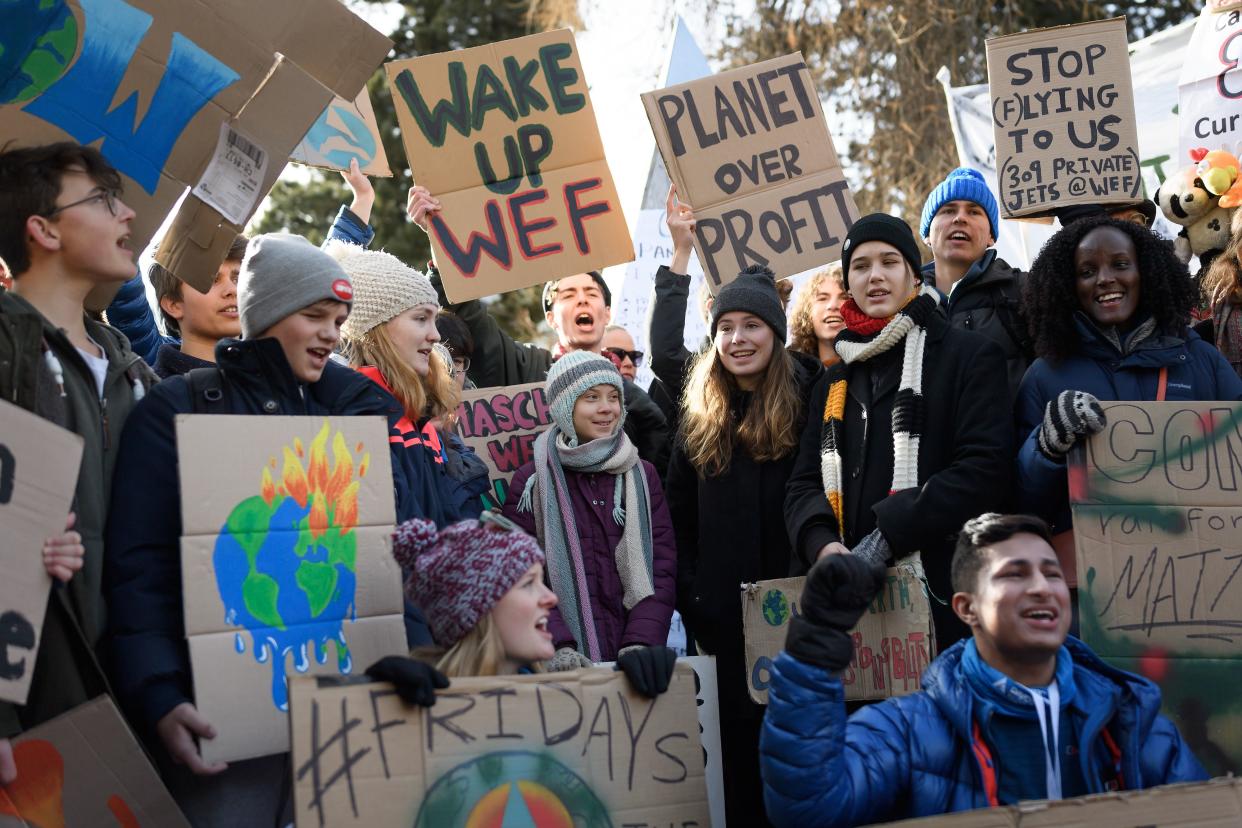 Swedish climate activist Greta Thunberg (C) takes part in a "Friday for future" youth demonstration in a street of Davos on January 24, 2020 on the sideline of the World Economic Forum (WEF) annual meeting. - Teenage climate activist said calls to the corporate elite meeting in Davos to disinvest immediately in fossil fuels had been ignored. (Photo by FABRICE COFFRINI / AFP) (Photo by FABRICE COFFRINI/AFP via Getty Images)