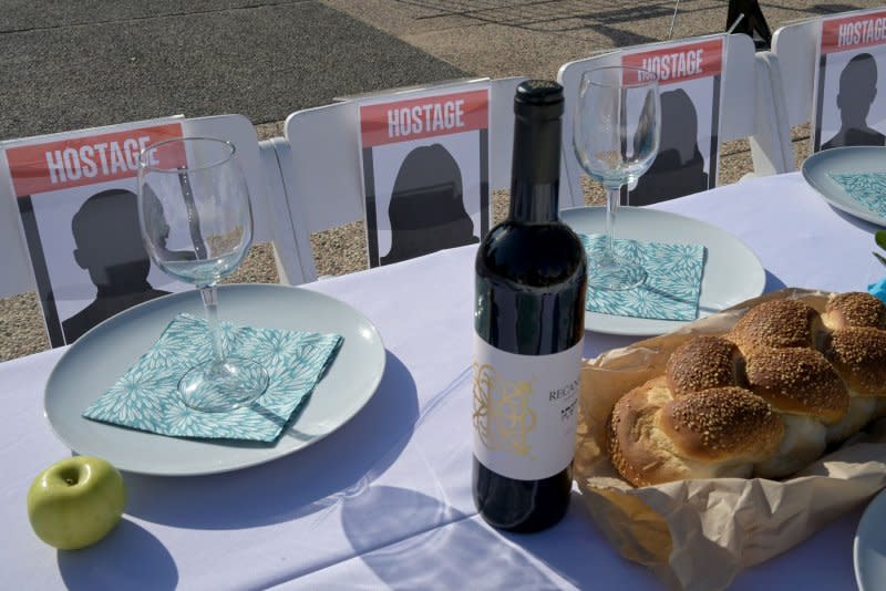 Setting empty tables for prisoners has been a global Jewish practice of symbolic protest since the 1960s. Families of hostages held by Hamas in Gaza welcome the Shabbat, the Jewish Sabbath, at a symbolic table with 203 empty chairs. Photo by Debbie Hill/UPI