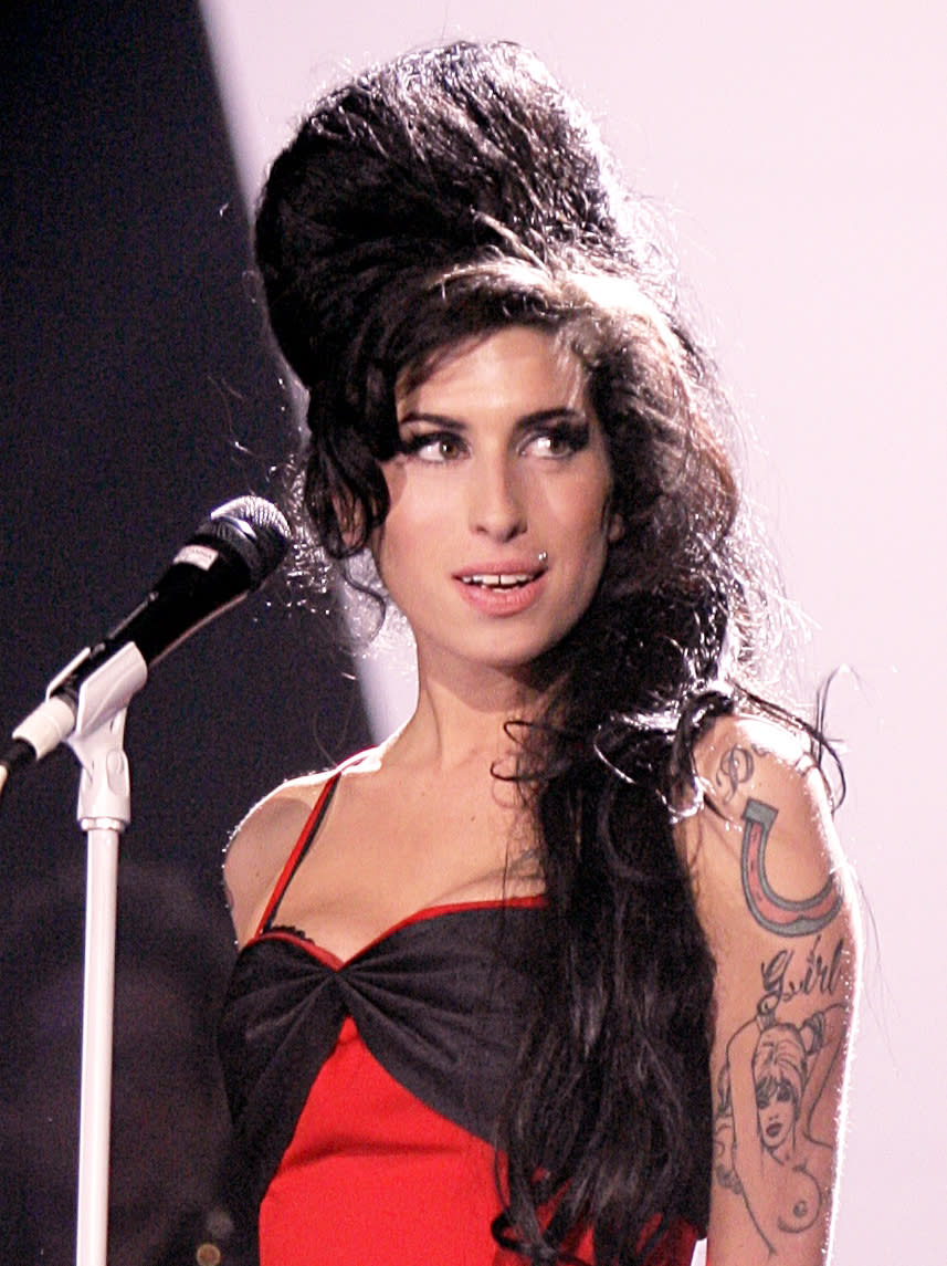 <p>No iconic hair round-up is complete without Amy’s infamous beehive. <em>[Photo: PA] </em> </p>