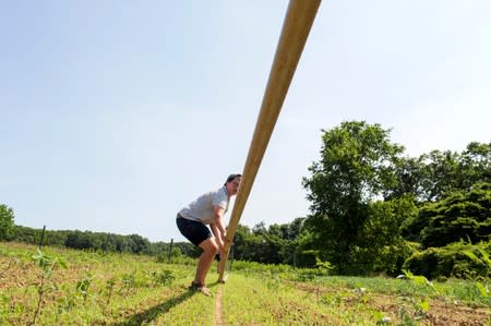 Layton Guenther, director of Quail Hill Farm, moves irrigation pipe in Amagansett