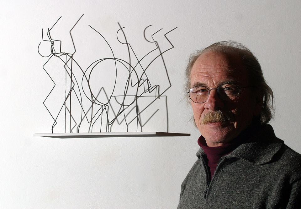 Jim Mason with one of his works, "Battle of the Greeks and Amazons," in 2003.