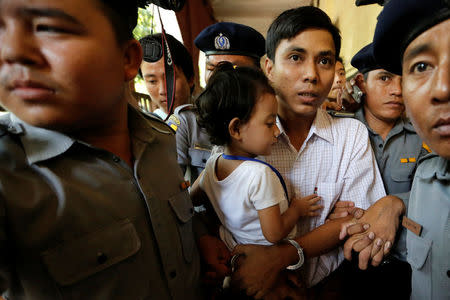 Detained Reuters journalist Kyaw Soe Oo carries his daughter Moe Thin Wai Zin during a break at the court hearing in Yangon, Myanmar April 20, 2018 . REUTERS/Ann Wang